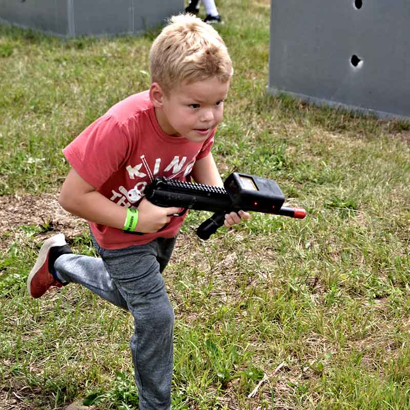 Kid running on the laser tag field